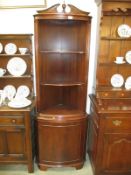 A mahogany corner cupboard