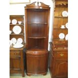 A mahogany corner cupboard