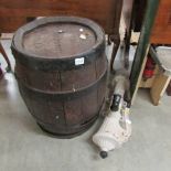 An oak barrel and a cast iron garden water pump.