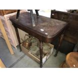 An Edwardian mahogany fold over card table