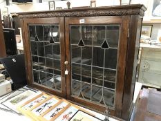 An oak lead glass bookcase