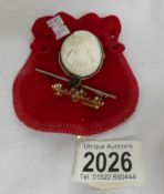 A vintage natural coral brooch of a young woman together with 2 further brooches.
