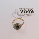 An 18ct gold ring set diamonds and central sapphire, size R. Approximate gross weight 4 grams.