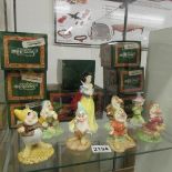 A boxed set of Royal Doulton figurines being Snow White and the seven Dwarfs.