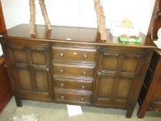 A dark wood sideboard,