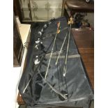 A compound bow with arrows in black case