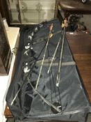 A compound bow with arrows in black case