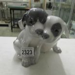 A Royal Copenhagen figure group of 2 pups with markings underside 1452/2600.