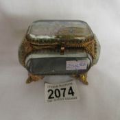 A gilt and glass jewellery casket with picture top (possibly French).