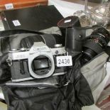 A Canon SLR camera, lenses, motor drive, filters, flash etc.