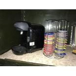 A Bosch Tassimo tea/coffee maker and pod rack with quantity of pods