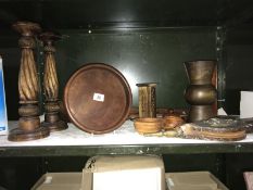 A shelf of wooden items incl. candle sticks etc.