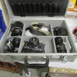 A cased Canon AE-1 camera with winter Olympics cap and 3 lenses etc.