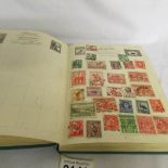 A Nelson stamp album of world stamps.