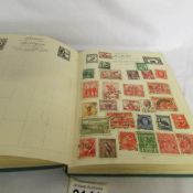 A Nelson stamp album of world stamps.