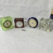 4 small glass/perspex cased clocks.