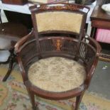 A Victorian mahogany inlaid elbow chair.