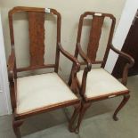 A pair of walnut elbow chairs.