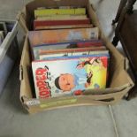 A box of children's books including old annuals.