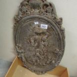 A cast iron wall plaque,