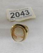 An oval ladies cameo ring in a gold mount of a female profile, dated Birmingham 1975,