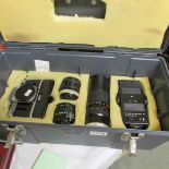 A cased Canon AR-1 camera and 3 lenses etc., (including 2 Canon).