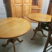 A pair of oak tripod tables.
