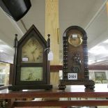 2 old mantel clocks, one with floral emblem and the other with windmill scene.