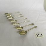 7 monogrammed silver teaspoons, approximately 95 grams.