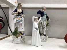 A pair of 12" tall bisque figures with crown mark on bottom and one other figure (slightly a/f).