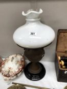 A Victorian oil lamp with shade.