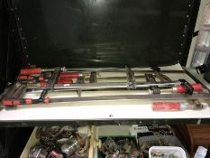 A shelf of various G clamps.