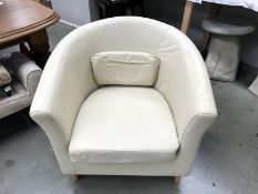 A Cream leather Tub chair.