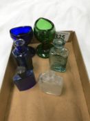 2 eye baths (blue and green) and 4 small medicine bottles.