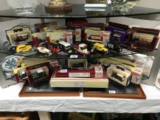 A large quantity of boxed and unboxed die cast cars etc., and 2 framed metal images of cars.