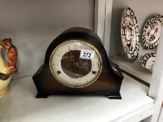 A wood cased mantel clock.