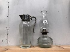 An oil lamp and a glass ewer.