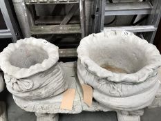 A large and a small sack shaped garden planters.