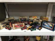 A quantity of boxed and unboxed die cast cars.