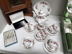 A 21 piece Royal Albert tea set and 2 cased sets of knives.