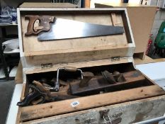 A vintage case of carpenter's tools including saws, planes etc.