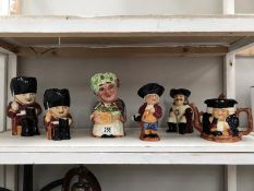 A shelf of Toby and character jugs including Shorter.