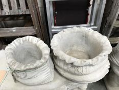 A large and small sack shaped garden planters.
