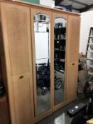 A 4 door wardrobe having 2 mirrored doors.