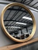 A large gilt framed circular mirror.