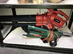 An electric garden leaf blower, a Black and Decker electric pruner etc.