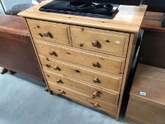A 2 over 4 pine chest of drawers.