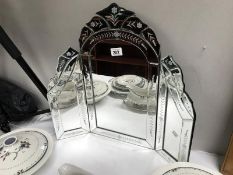An ornate dressing table mirror.