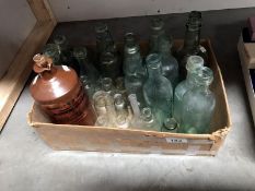 A box of old glass bottles and one stoneware bottle.