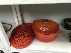 A Curvoisie cast iron casserole pot and 3 pot stands.